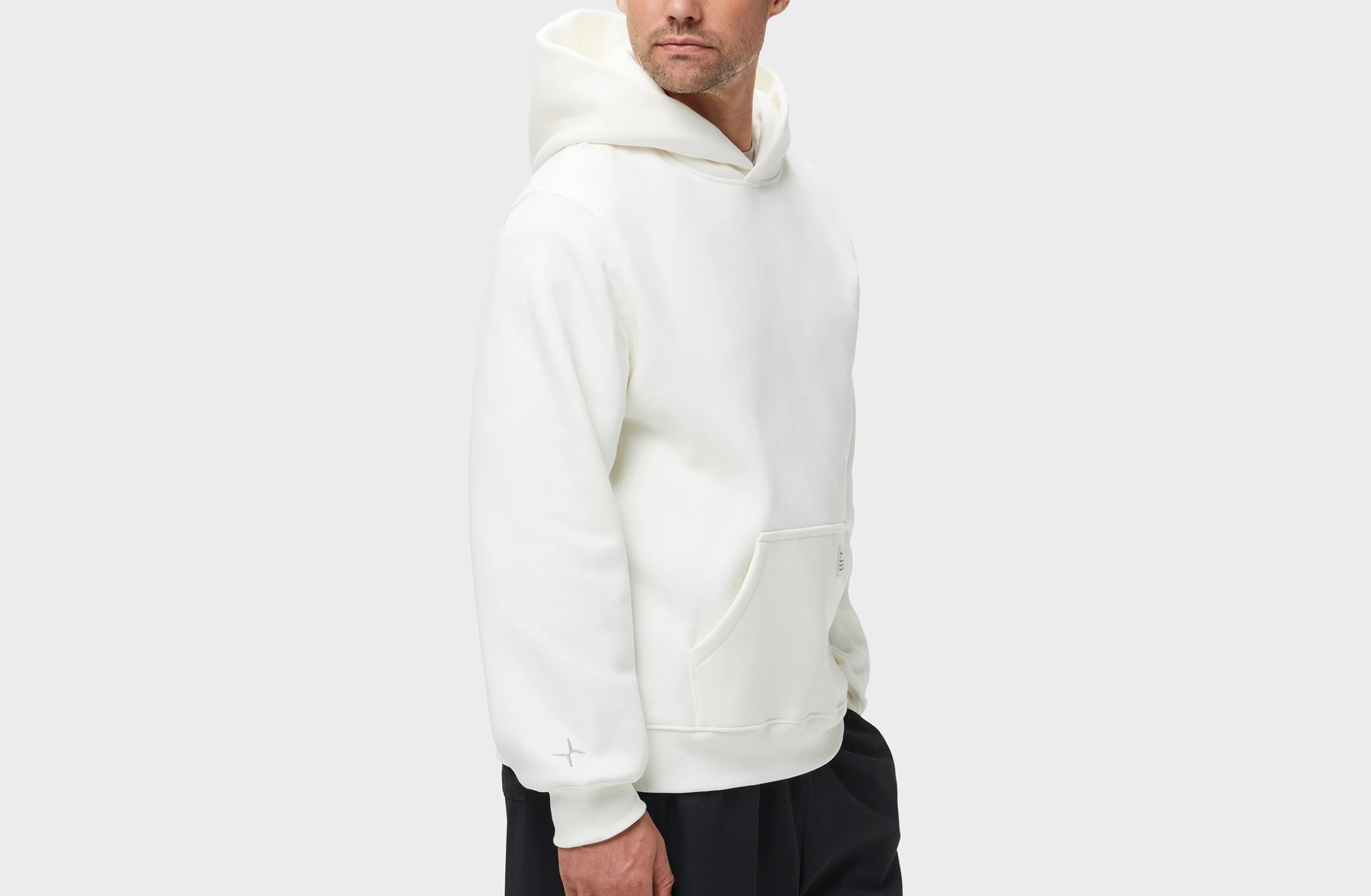 White hoodie with big Polestar wordmark on left sleeve