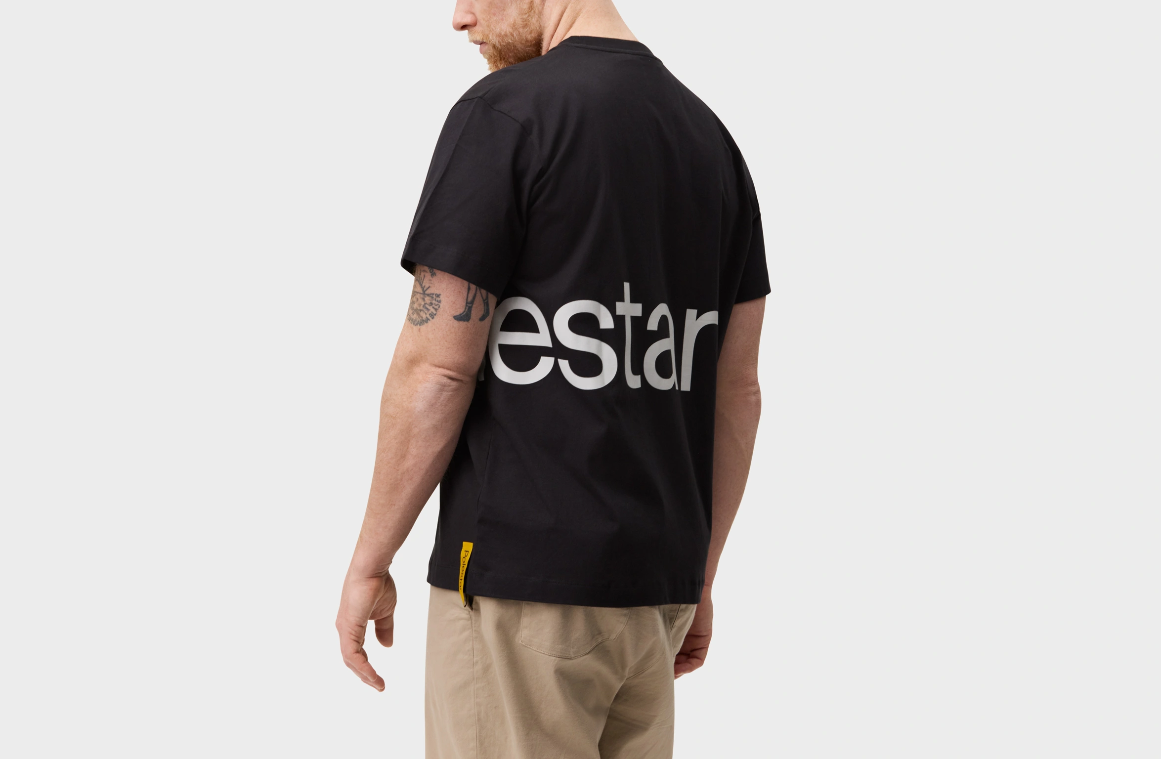 Black t-shirt with a Polestar wordmark stretching from the front to the back