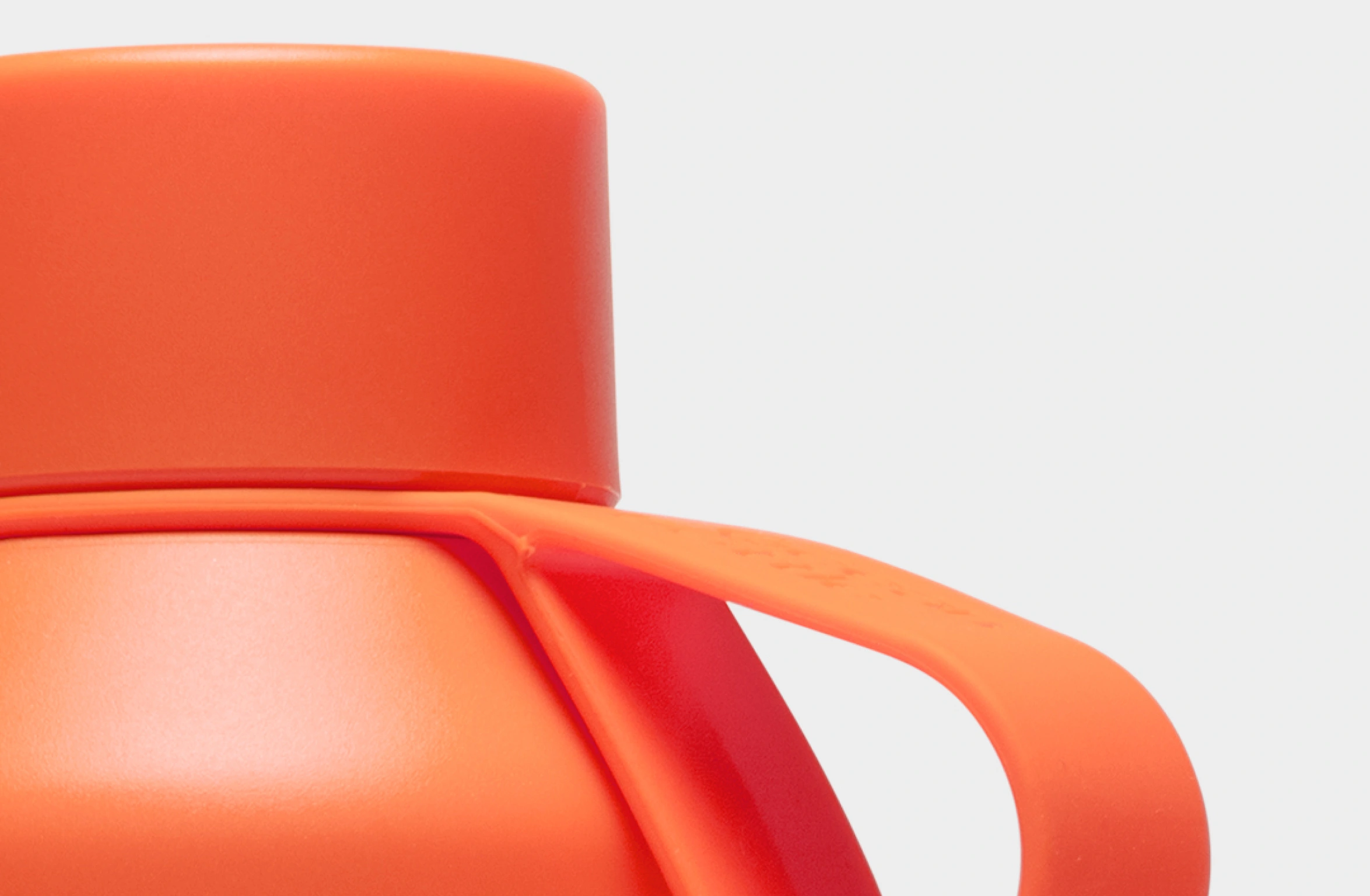 Orange water bottle with white Polestar wordmark