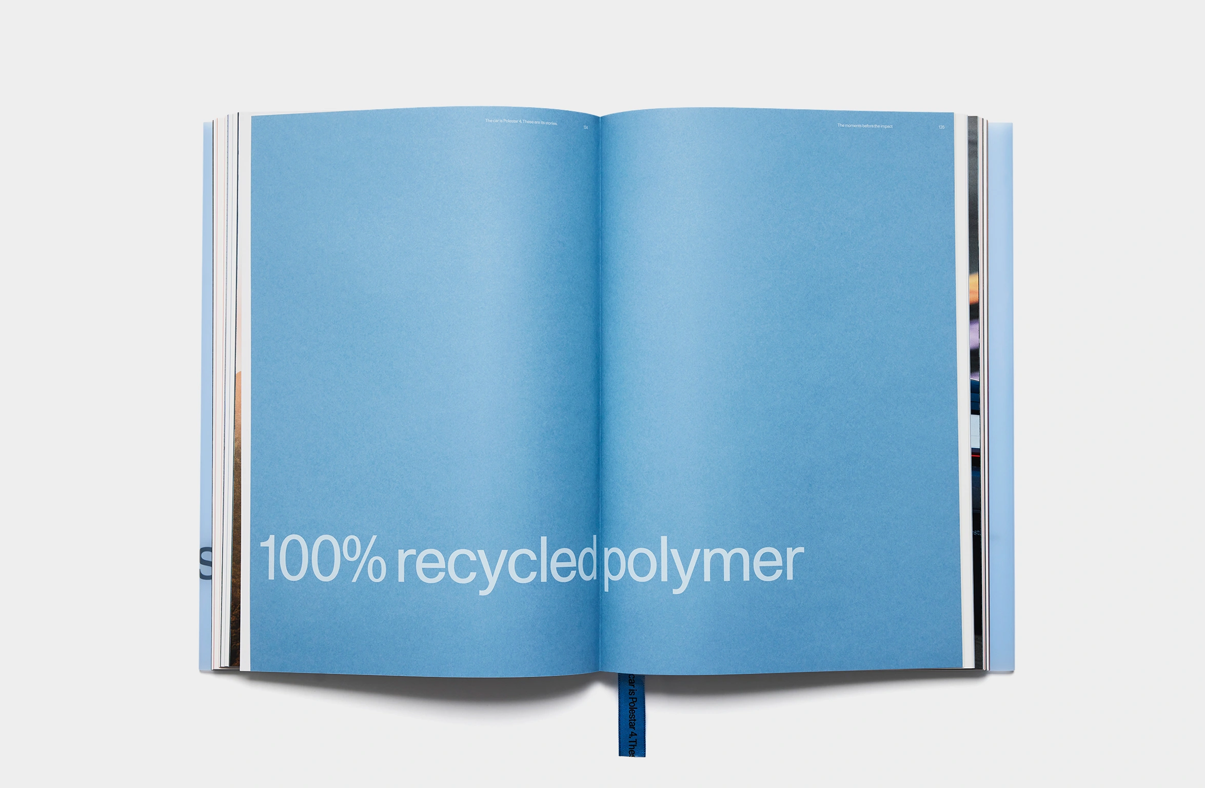 A light blue book with subtle embossed text and a blue bookmark