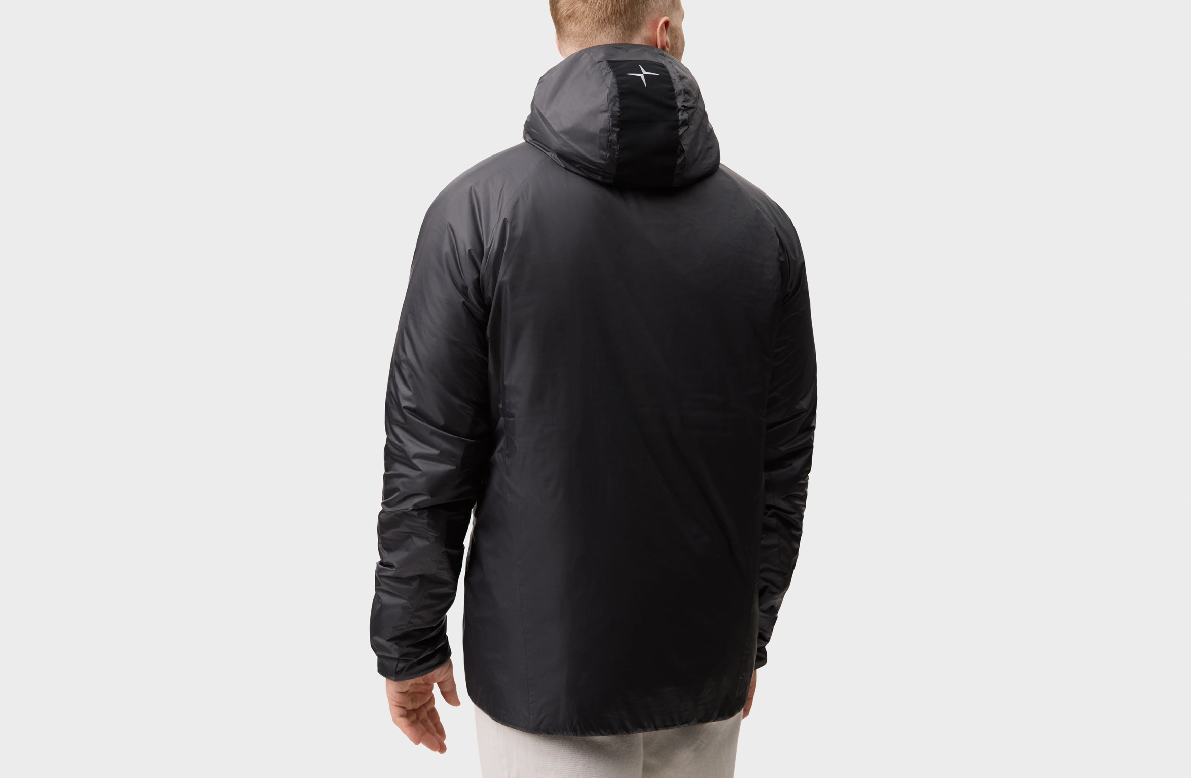 Black lightweight jacket with hood, full zipper, and discreet Polestar wordmark
