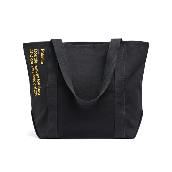 Black tote bag with a small yellow Polestar wordmark