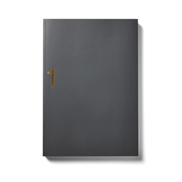 A dark hardcover book with a gold "1" on the cover