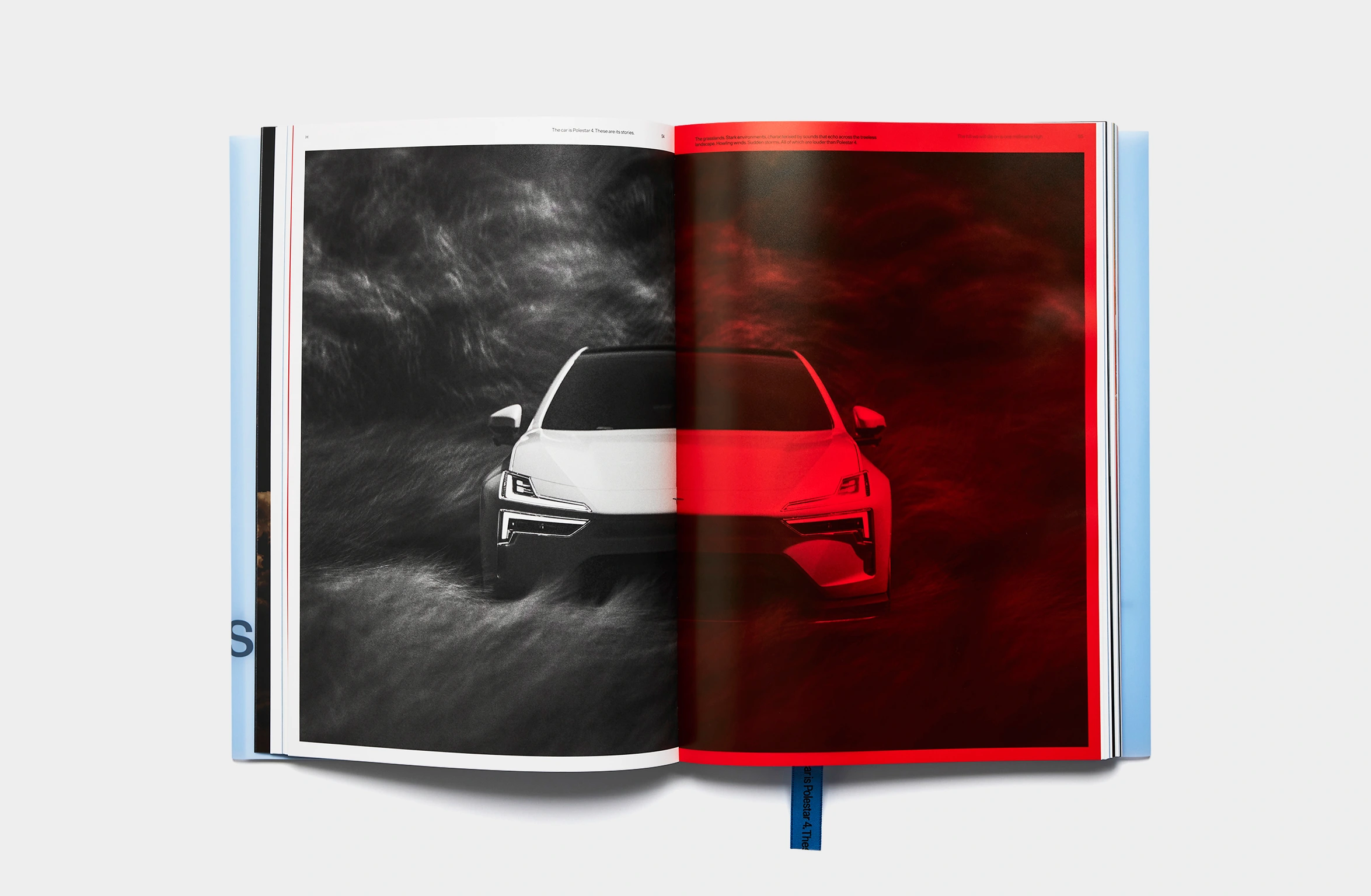 A light blue book with subtle embossed text and a blue bookmark.