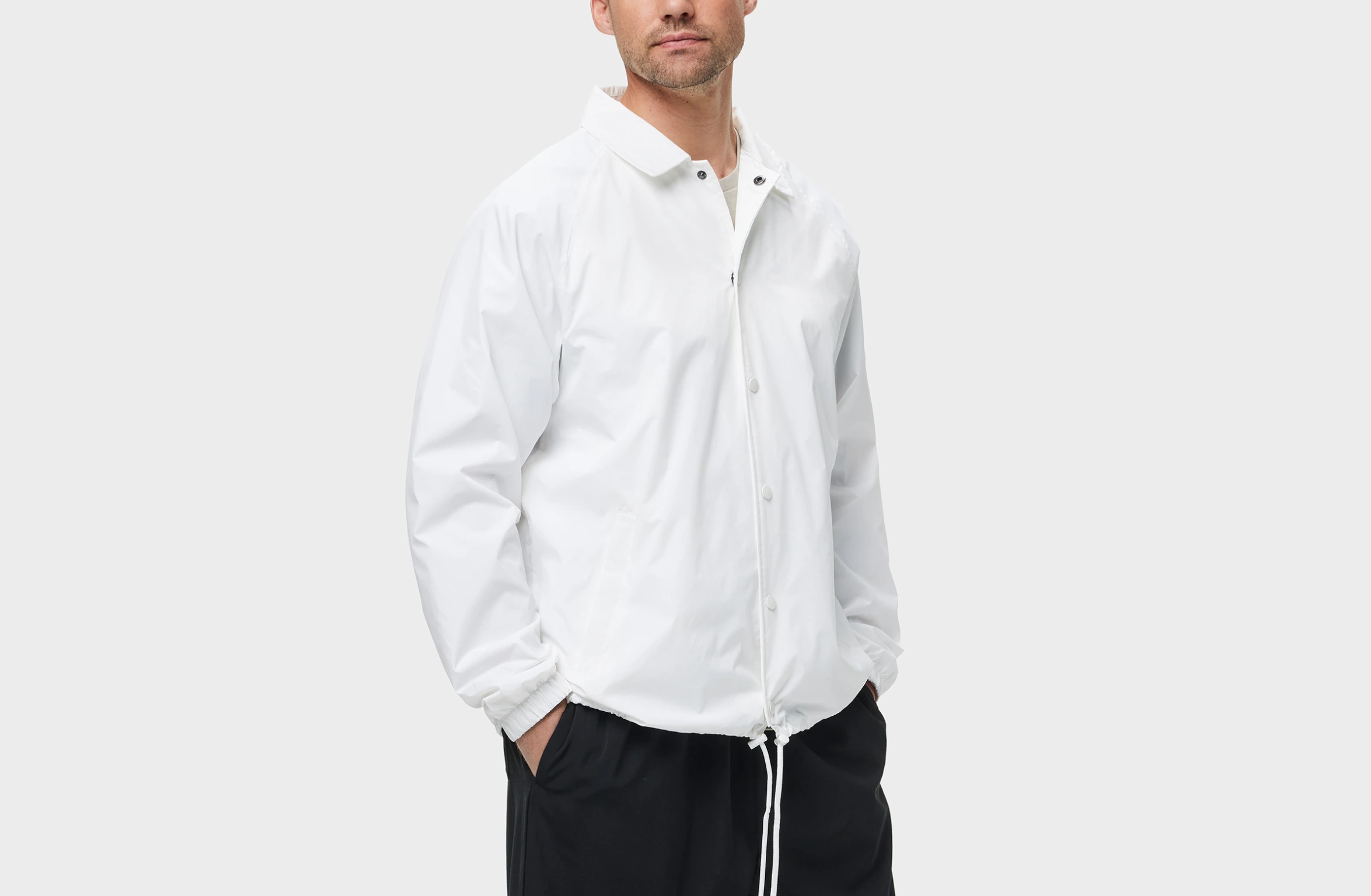 White jacket with elasitc cuffs, buttons and a drawstring waist.