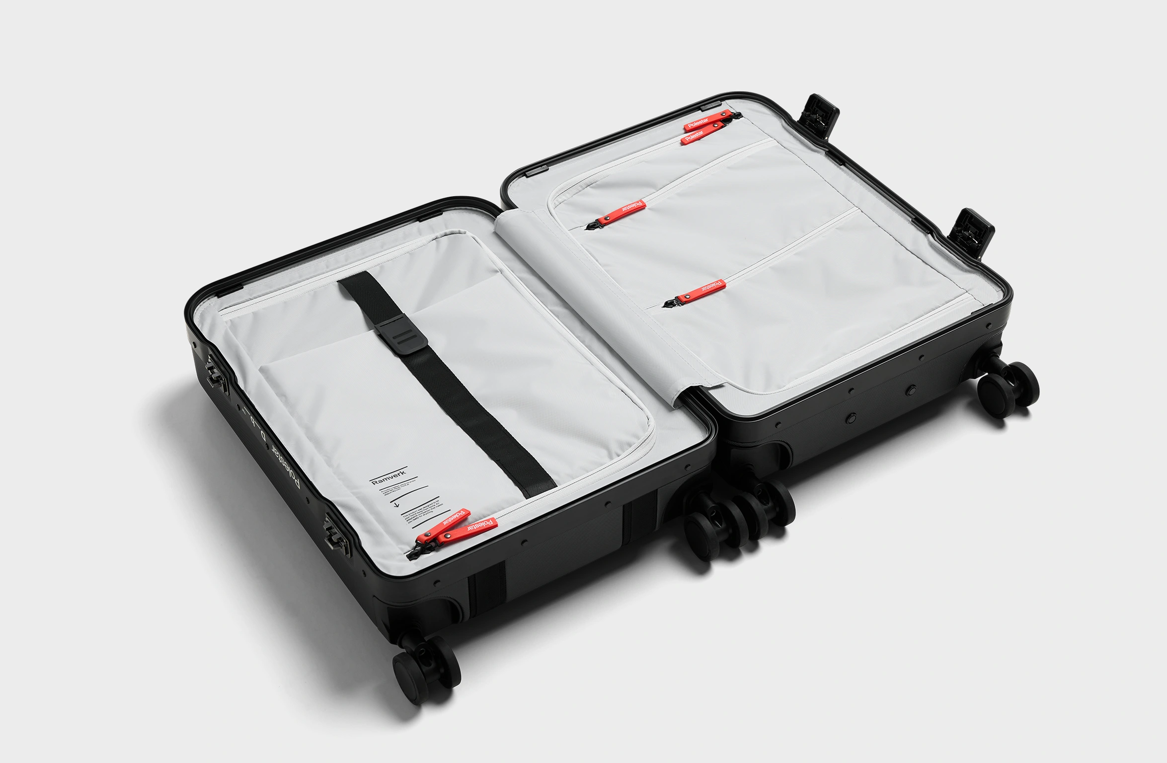 Black hard-shell suitcase with reinforced edges, secure locks, and Polestar x Db branding on the side.