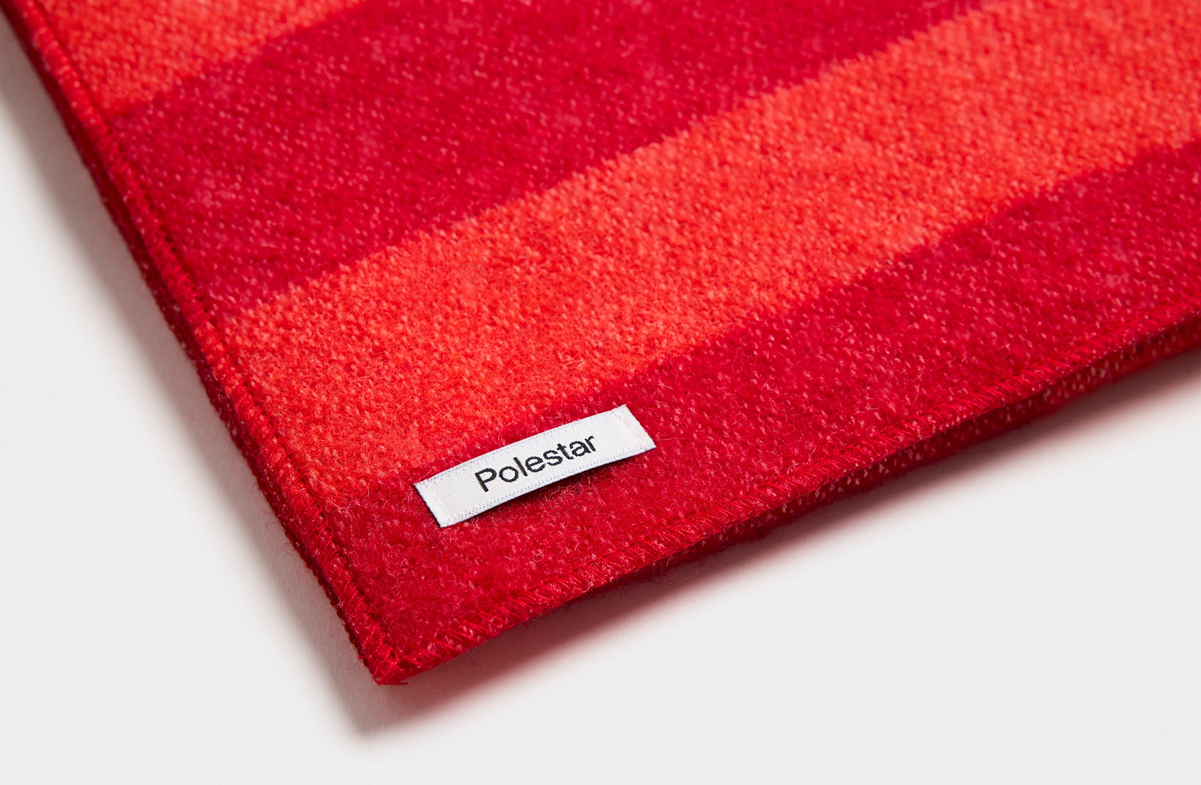 Red scarf with big tone-on-tone Polestar wordmark