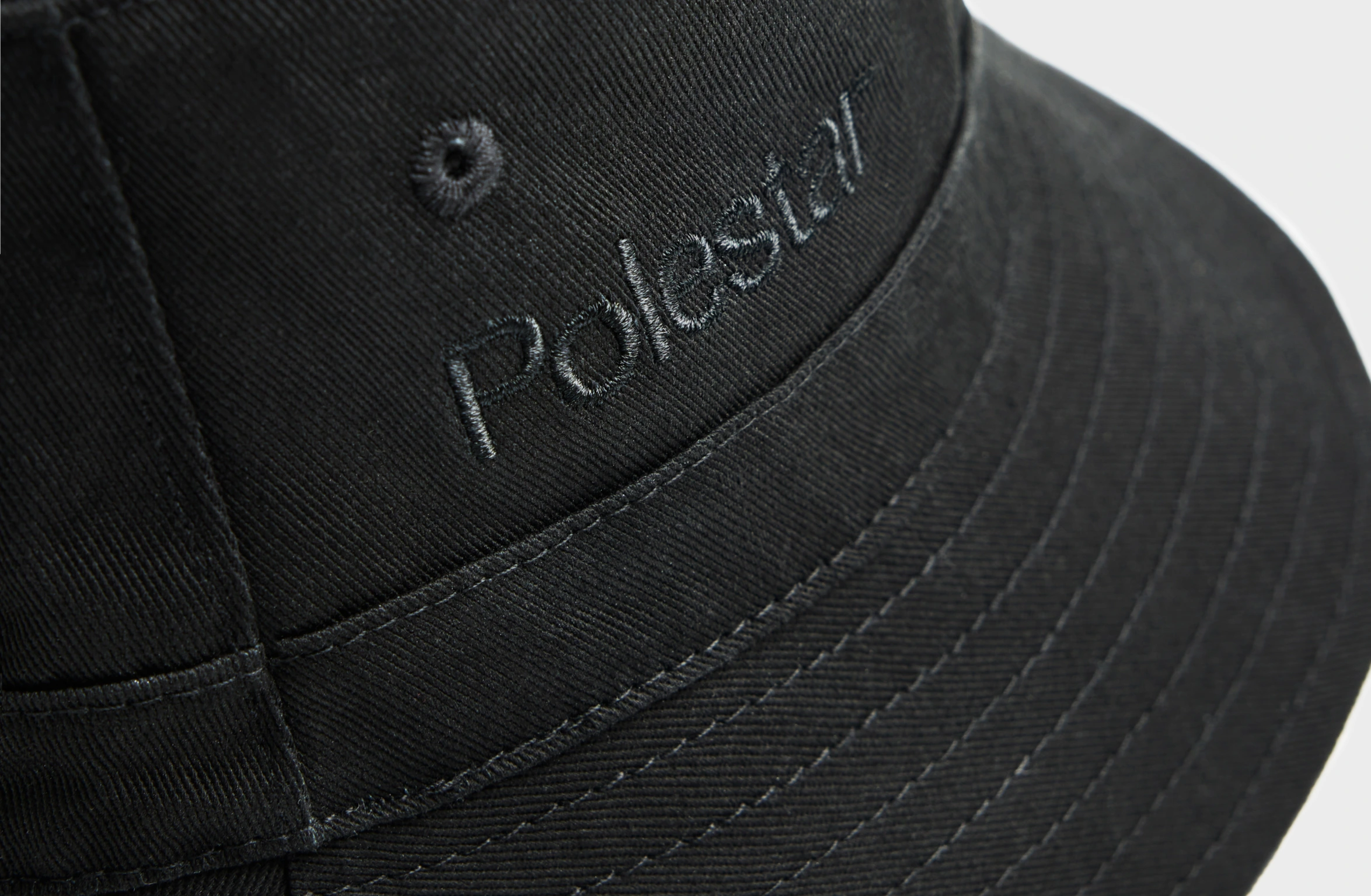 Black bucket hat with tone-on tone Polestar wordmark on the side