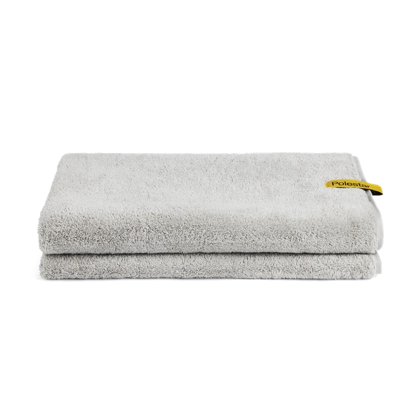 Gray towel with a yellow side tag with black Polestar wordmark