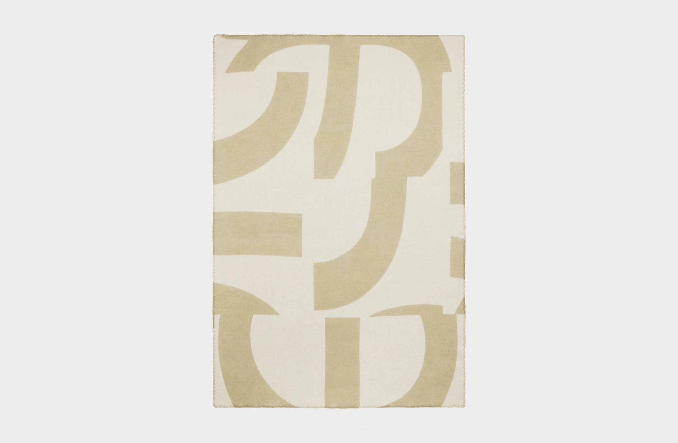 Merino wool blanket in sage green with an abstract pattern