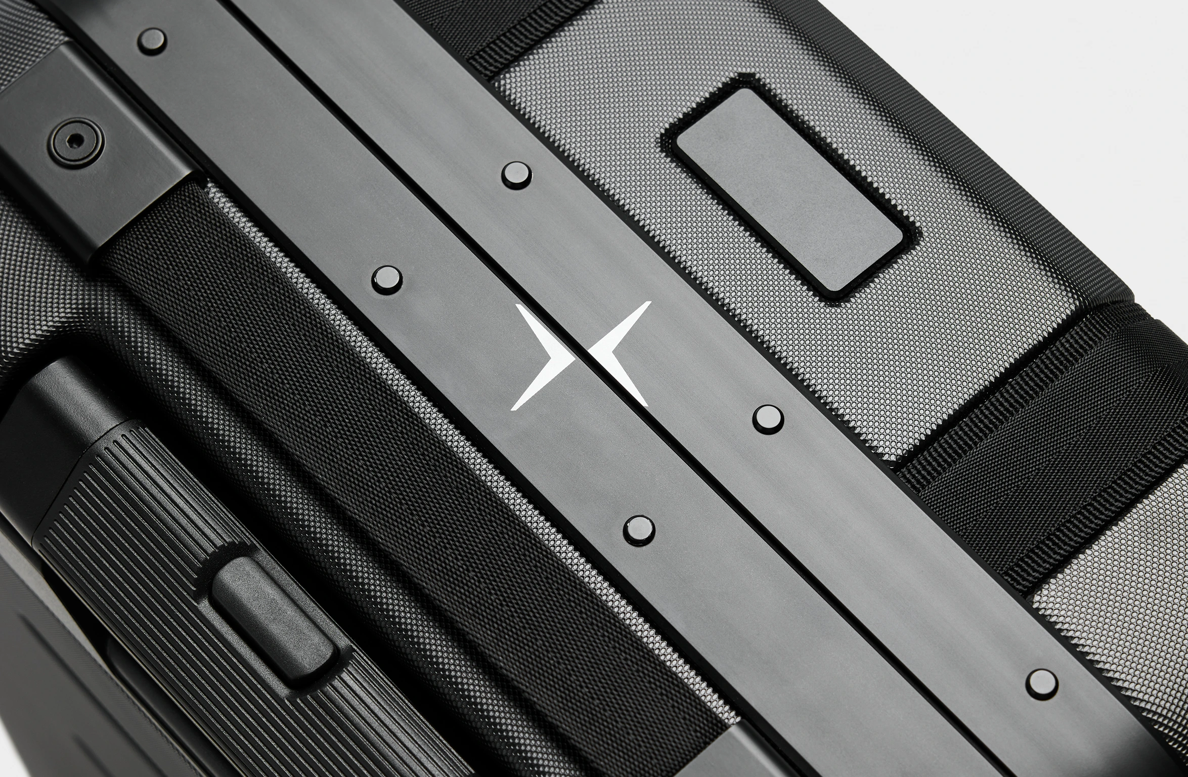 Black hard-shell suitcase with reinforced edges, secure locks, and Polestar x Db branding on the side.