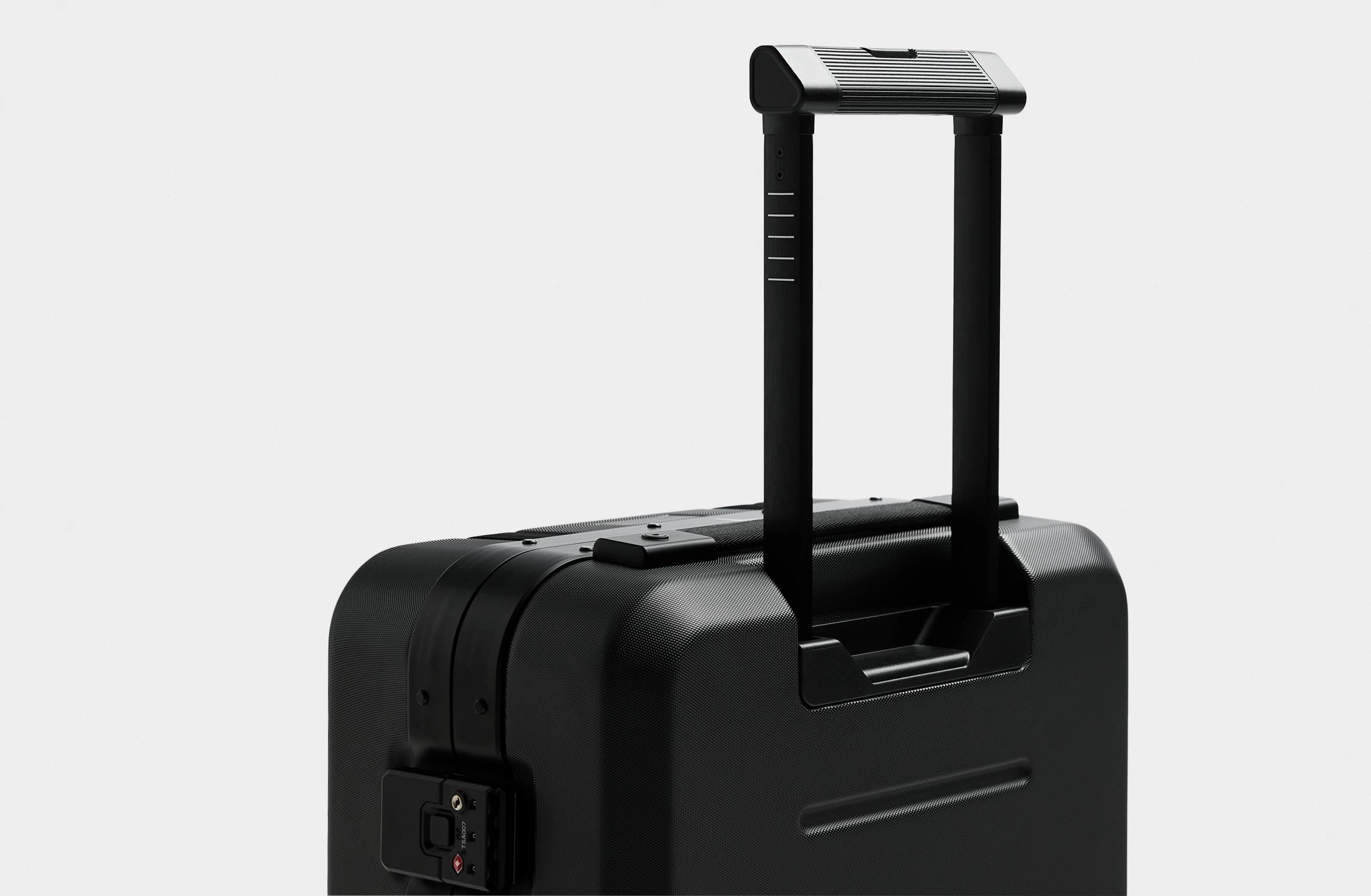 Black hard-shell suitcase with reinforced edges, secure locks, and Polestar x Db branding on the side.