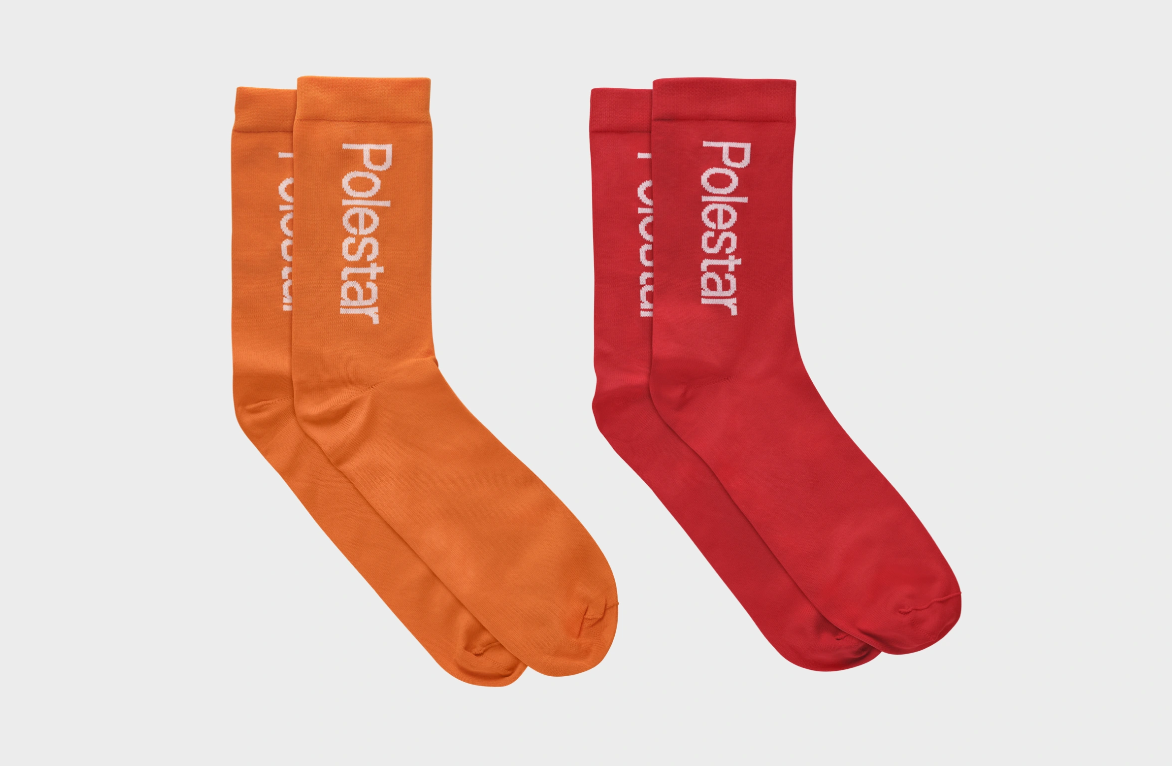 Package with Socks with Polestar Wordmark. One in orange and one in red
