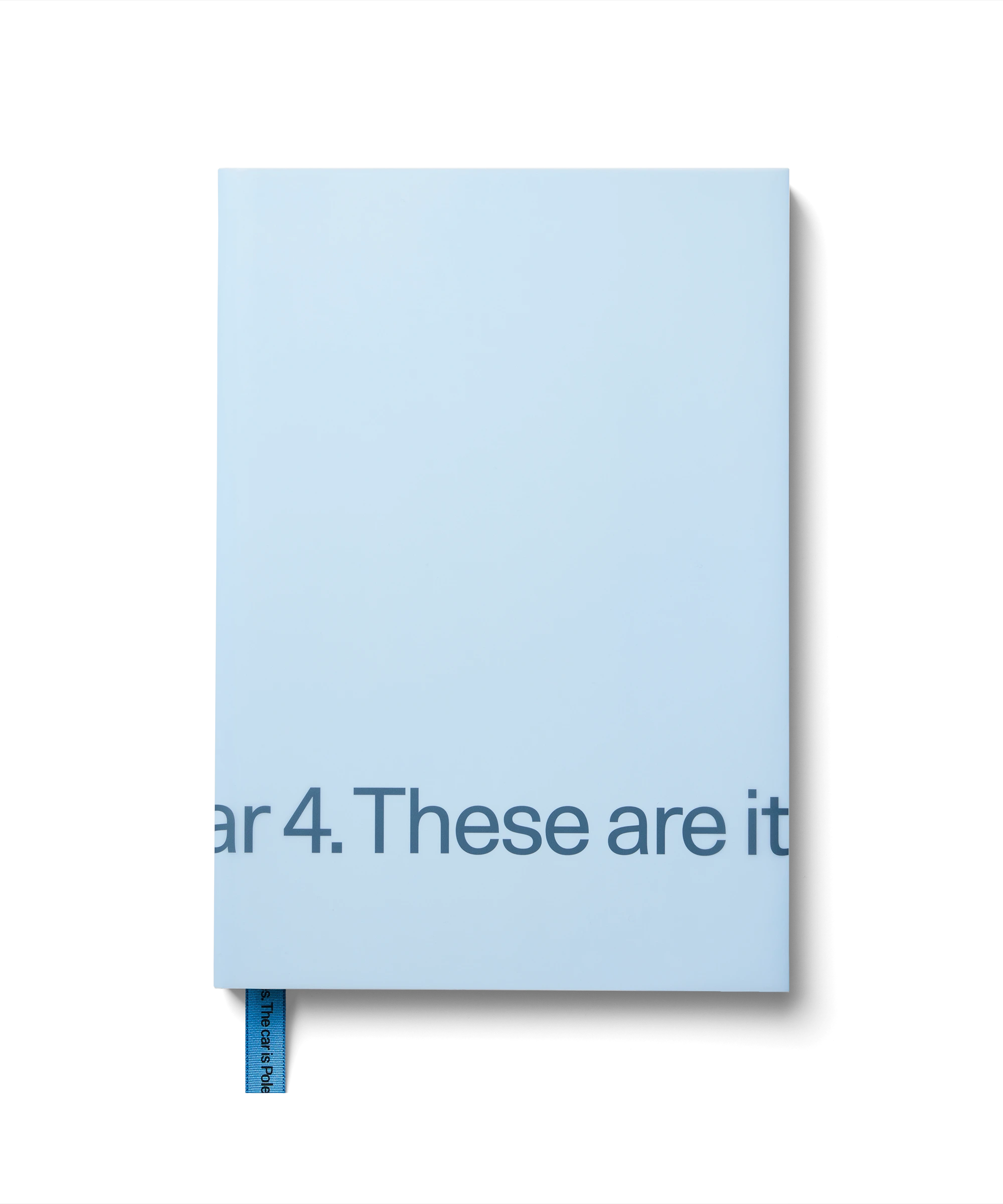 A light blue book with subtle embossed text and a blue bookmark.